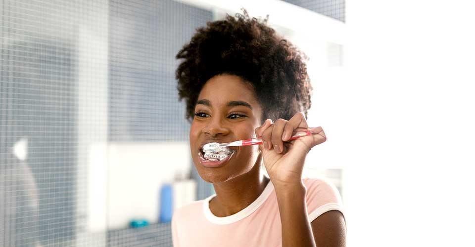 Teen girl brushing teeth