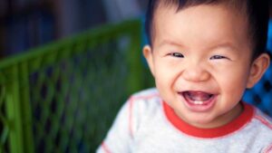 baby smiling showing teeth