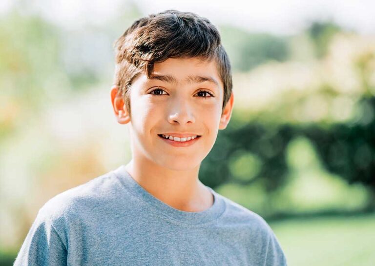 Child with a healthy smile after dental sealants.