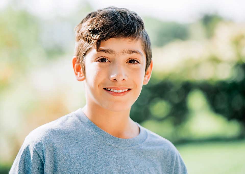 Child with a healthy smile after dental sealants.
